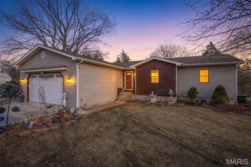 Ready to leave the city for the Country air? Need more space? Want to listen to the peaceful flowing creek after a mid day rain? Have some old or new projects you are wanting to start or something to restore? Need to park you RV out of the weather? Ready to gather walnuts for a special recipe or persimmons to make a delicious pie? This property answers YES to all of these questions. 4 bedroom, 2.5 bath Ranch home located in Washington County.  House has plenty of space for everyone, and engineered wood in the eat in kitchen and living room and hallway. 3 very nice sized bedrooms on the main floor. Primary bedroom offers a half bath with a walk in closet that has been updated with laundry facilities. Lower level has the potential for a separate living area for someone with a family room, full bath, and bedroom that has its own access from the walk out.  There is also another washer/dryer hookup in the storage area.  Tankless water heater ensures quick, efficient hot water for you!!! The deck off the back house has a roll out shade to keep you out of the sun while sitting outside.  Back yard is already fenced in. Now comes the BEST PART...... There is a separate approximately 1200 sq ft. garage/workshop with a door big enough to pull in your RV. There is 3 sources of heat, a 1/2 bath, and a pored concrete foundation. Also a very nice covered sitting area to watch the wildlife in the yard take advantage of the walnut and persimmon trees. This all sets on close to 4 acres with enough outdoor space to have summer gatherings or fall bonfires! Best way to describe this amazing property is ONE OF A KIND and these do not come available very often.