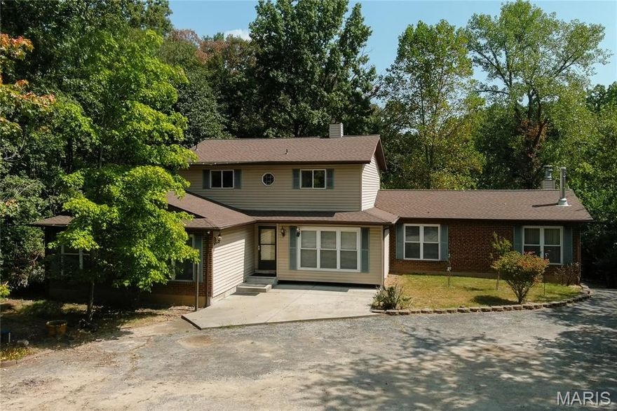 Looking for privacy and seclusion yet close to everything? With some TLC this home could be your oasis away dream home! This 3.3 acre retreat is located within a subdivision that is close to shopping, restaurants and all the conveniences you need. The wooded lot takes you away from your daily hustle and bustle! The property offers a huge great room with 3 sets of sliders that open to a massive deck overlooking this serene property. The kitchen with skylight offers a large walk-in pantry and is open to breakfast room with woodburning fpl and bow window looking over beautiful lot. There is a private dining room. Main floor primary bedroom boasts 2 large walk-in closets, 10x10 ensuite bath and is just off sitting room or office.  Half bath, laundry room plus another room that could be office or craft area complete the main level. 2 ensuite bedrooms upstairs each with super large closets and bathrooms plus each walk out to the second floor deck overlooking yard and wooded acres. The lower level has a huge unfinished room that also has slider to covered patio area. 2 car oversized garage with plenty of extra parking for guests plus a utility shed for your yard equipment.. Home needs updating but the layout and lot are amazing! Updates: Roof 2 years old, one central AC is new, Seller will escrow for a new septic system. Lower deck is 28x24. Upper deck is 24x11. Seller prefers an as-is offer and is unable to make repairs. Call Pam for additional information. OFFERS DUE 9/19 6PM