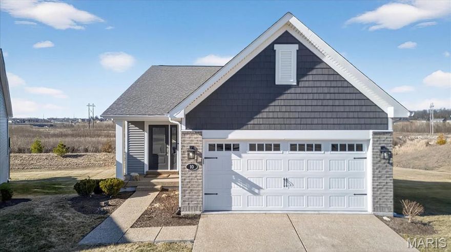 Three-year-new Fischer & Frichtel ranch in the desirable Cottleville Trails community offering low-maintenance, move-in ready living. The home features coffered ceilings, a timeless neutral color palette, a large kitchen with center island, and an open, light-filled layout ideal for everyday living and entertaining. Backs to undisturbed land for added privacy and peaceful views. The walkout basement is ready to finish with a framed-in bedroom and a rough-in bath already in place. Enjoy a short golf cart ride to everything Cottleville has to offer plus quick highway access. New construction without the wait or the price tag. Lawn maintenance and snow removal included with HOA payment.