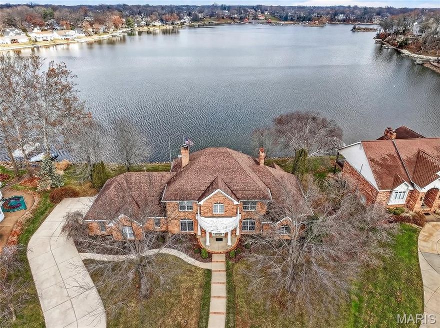 NEVER BEFORE OFFERED! This fabulous waterfront on a level lot offers a timeless, elegant floor plan well ahead of its day. High Ceilings, large open rooms, and a graceful flow await your decorator touches and updates. Upon opening the front door, you see sparkling water at every glance and will be in awe by the custom curved staircase, elegant study, and huge dining room with fireplace. The expansive great room has a sea through fireplace, wet bar, and is open to the hearth room and kitchen. This primary suite is positioned lakeside with a French door to the paver patio and offers two walk in closets and an incredibly generous bath with his & hers water closets and bidet. There is lots of glass everywhere, enhancing the water views and creating the lake life ambiance! The huge kitchen could embrace the island of your dreams and offers enough space for anything you want to create. A main floor laundry and 3 car garage complete the package. Over 200’ of level shoreline make this the perfect lakeside setting for any family dynamic!