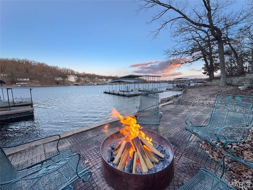 A resort-inspired custom-built lakefront retreat w/ spectacular views on the 8mm, offering upscale design & proven short-term rental appeal. Fully furnished - just bring your friends, family & suitcases and let the vacation begin! This open-concept sleeps 20 & showcases vaulted ceilings in a grand hearth room, highlighted by dramatic windows framing the water. A well-appointed kitchen features stainless steel appliances, custom cabinetry, granite countertops & breakfast bar + additional dining area to feed a crowd. 6 spacious bedrooms include 2 lakeside, private king suites w/ spa-style full baths, & a playful 10-person bunk room. Outside, enjoy a thoughtfully-designed lakeside shower house, spacious screened-in patio, fire pit, barbecue grills, & a fully functional tiki bar with water & electric. Situated in a wide, deep-water cove perfect for swimming, fishing & water sports, the property also includes a two-slip dock w/ tri-toon lift, 2 PWC platform & swim deck. Ideally located by land & water just minutes from dining, entertainment, & local attractions, this exceptional home delivers luxury craftsmanship, lifestyle, & strong rental opportunity in one remarkable property. Proven STR at $1000 per day. The house next door is also for sale by the same owner - feel free to tour both - 32951 Green Hills Rd.