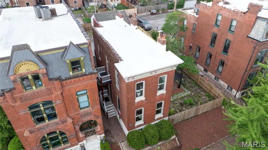 Step into this beautifully renovated home where thoughtful updates meet timeless character. A new TPO roof, EV charging station, and a spacious two-car garage set the tone for modern convenience, while newly refinished original wood floors and updated lighting and plumbing fixtures, plumbing stacks, and copper water lines along with updated  electric enhances the home throughout.

The heart of the home is the redesigned kitchen, featuring a new island and sleek Frigidaire stainless steel appliances—perfect for both everyday living and entertaining. Three fully new bathrooms showcase quality finishes, and the home offers two wood-burning fireplaces, including a charming stove, adding warmth and character.

A flexible first-floor bedroom—currently staged as a living space—offers versatility to suit your needs. Upstairs, the primary suite is a true retreat, complete with a private deck overlooking the yard, a spacious walk-in closet, and a beautifully appointed bath with a large shower. A second-floor laundry adds convenience, with an additional laundry setup in the basement.

The upper level also includes a generously sized front bedroom and a second full hall bath. The semi-finished lower level offers incredible potential, featuring a private-entry space with a full bath—ideal for a guest suite, office, or income-producing opportunity, as zoning allows.

Situated on a rare double lot in the upper quadrant of Soulard, this property offers space seldom found in the area—plenty of room to create your own outdoor oasis, even a pool. The original wrought iron fence stands as a nod to the home’s history, while its location in sought-after Soulard Heights places you just moments from the neighborhood’s vibrant energy, festivals, and charm.
2 car garage with an additional off street parking space for that treasured golf cart and space to add more parking should you need it.