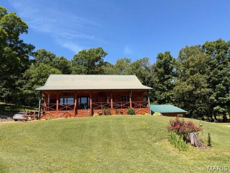 Tucked away in a breathtaking setting on 13 +/- scenic acres, this stunning log cabin retreat offers the perfect blend of rustic charm and peaceful country living. From the moment you arrive, you'll fall in love with the inviting covered front porch, ideal for soaking in the beautiful views and quiet surroundings. Inside, the home features soaring raised ceilings, warm wood finishes, and an open welcoming feel throughout. The loft-style area overlooking the main living space makes the perfect office, reading nook, or additional guest space. Offering 3 bedroom and 2.5 baths, this property was designed for both comfort and relaxation. A spacious 1200 +/- sq ft shop building with electric offers the perfect place to store boats, side by sides, equipment, and all your outdoor toys with room to spare. Enjoy mornings in the garden area, evenings on the covered porch, and endless privacy with adjoining wooded acreage surrounding the home. Located just approx. 2 miles from Current River, this property would make an incredible weekend getaway, Air Bnb investment, or your forever home. This is for those craving nature and tranquility; you will be sure to fall in love!