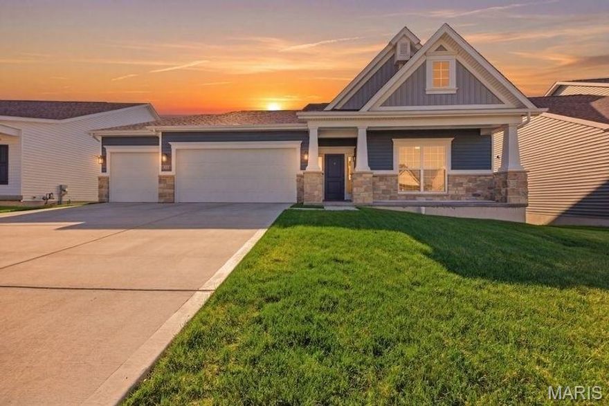 This 2-year-old Universal Design Sierra by Consort Homes was built with the future in mind—offering the kind of thoughtful design that makes everyday living easier, safer, and more enjoyable for years to come. With no-step entry from the garage and zero-entry showers, this home removes barriers without compromising style.

From the moment you walk in, the open layout, soaring 9' and 11' ceilings, and wall of windows create a bright, welcoming space anchored by a cozy 42” gas fireplace—perfect for both quiet evenings and hosting family and friends.  The kitchen is as functional as it is beautiful, featuring granite countertops, upgraded two-tone cabinetry with soft-close drawers, glass accents, stainless gas appliances, and a walk-in pantry with oversized 8’ doors—designed to keep everything within easy reach.  Your main-floor primary suite offers a peaceful retreat with a tray ceiling and a zero-entry walk-in shower, separate vanities, and a layout designed for comfort, convenience, and long-term livability. A private study with 8’ glass French doors gives you the flexibility to work from home or enjoy a quiet reading space, while an additional zero-entry hall bath adds everyday practicality.

The 9' finished walk-out lower level provides incredible flexibility—ideal for multi-generational families, extended stays, or entertaining—with a spacious rec room, bedroom, full bath, and laundry.

Outside, enjoy a low-maintenance lifestyle with a fully fenced yard, irrigation system, deck, and a reinforced patio already wired for your future hot tub—so you can relax the moment you're ready.  Energy-efficient upgrades like solar panels, sealed ductwork, Low-E windows, and a full energy seal package help keep utility costs down while maintaining year-round comfort.

This is more than a home—it’s a smart investment in comfort, accessibility, and peace of mind for the years ahead.