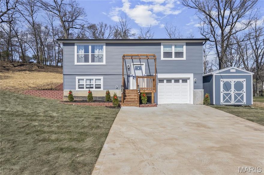 Why wait to build and landscape? This new construction home features $20,000 of newly completed exterior work, turning the lot into a functional, beautiful retreat. From the stunning new retaining walls to the lush sod and tree removal, all the heavy lifting is done, allowing you to simply move in and enjoy your private oasis**Brand-New Construction: Stunning 3-Bedroom, 2-Bath Split-Level Home with Modern Finishes and Ideal Location** OVERSIZED LOT prime location near all of valley parks best amenities. This newly constructed split-level home offers the perfect combination of contemporary design, exceptional craftsmanship, and functionality. Built with the finest materials and attention to detail, this property is ideal for those seeking a move-in ready home with low maintenance and modern conveniences. From the durable, low maintenance **vinyl siding** to the spacious backyard with a private back deck, every inch of this home has been thoughtfully designed for comfort and durability. The bright, open-concept main level features a large living room and dining area that flows seamlessly into the gourmet kitchen. The kitchen boasts **42-inch custom cabinetry**, elegant **granite countertops**, and premium **stainless steel appliances**—perfect for entertaining or cooking family meals. A pullout faucet adds convenience to the modern design, making kitchen tasks easier than ever. Down the hall, you'll find two well-appointed bedrooms, each with generous closet space. The beautifully finished full bath is a highlight, featuring a sleek **modern vanity**, cultured marble sinks, and contemporary fixtures. The fully finished lower level offers even more living space, including a spacious family room, a third bedroom, and an additional full bath. The oversized lower-level bath features a **tile stand-up shower**, offering a spa-like experience. A separate laundry room provides additional storage, and the **oversized one-car garage** includes extra space for your belongings. This West County Property is located in an unbeatable area, within walking distance of local parks and schools, and with quick access to major highways, including Highways 141, 270, Dorothy Ferry, and Highway 44. Enjoy the convenience of nearby recreational amenities, including multiple golf courses and outdoor spaces. Total heated living space is 1500 with extra garage space of 240 sq ft for a boasting 1700+ sq ft