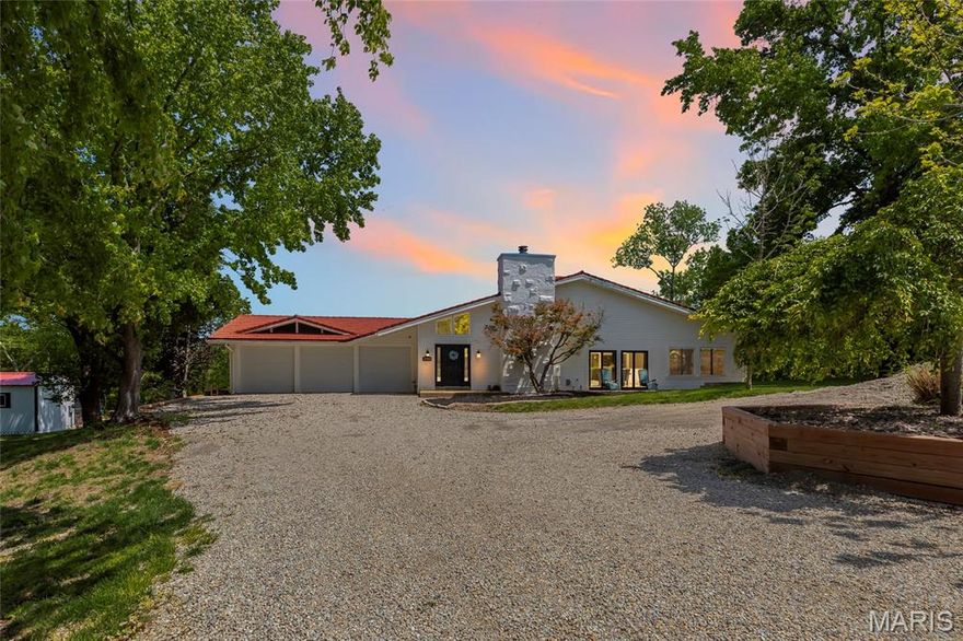 Set on 13 breathtaking acres in the rolling hills of Wildwood, this one-of-a-kind property offers a rare blend of privacy, natural beauty, and expansive living space. With over 6,200 square feet of living space, the home is anchored by a truly spectacular great room spanning over 1,000 square feet - featuring a soaring vaulted and beamed ceiling, multiple skylights, and walls of windows that flood the space with natural light while framing stunning views of the surrounding landscape.

The spacious primary suite is a private retreat, complete with a generous sleeping area, cozy sitting room, large walk-in closet, and an updated en suite bath with dual sinks, soaking tub, and separate shower. The eat-in kitchen combines charm and function with white lower cabinetry, open upper shelving, stainless steel appliances, and its own vaulted and beamed ceiling. Just beyond, the inviting hearth room with a woodburning fireplace creates the perfect gathering space.

Two additional bedrooms each offer walk-in closets and updated en suite baths, providing comfort and privacy for family or guests. The lower level adds incredible versatility with a custom playroom/kid’s hideout and two additional recreation areas.

Outside, the property is nothing short of extraordinary. Explore your own private trails, enjoy the peaceful meandering creek, or gather at the cleared camping site tucked at the base of the property. Evenings can be spent around the fire pit or relaxing in the hot tub under the stars. A gated private road with electronic access—shared with just two neighboring parcels—ensures both security and seclusion.

Additional highlights include a main floor laundry, powder room, oversized three-car garage, and two exterior storage spaces. The home is topped with a stone-coated steel roof system featuring a 50-year warranty for long-term peace of mind.

Located in the highly sought-after Rockwood School District, this is a property that simply cannot be fully appreciated without experiencing it in person. A rare opportunity to own a truly special piece of Wildwood.