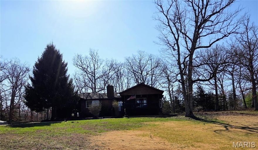 Welcome to your own private retreat! This beautiful brick home sits on 15 acres m/l that includes a 4 acre stocked lake - crappe, bluegill, bass & catfish - perfect for fishing, relaxing or simply enjoying the view. Inside you'll find a spacious layout with 3 bedrooms and 2.5 bathrooms, including a main level primary suite with a tray ceiling, walk-in closet, en-suite with a walk in tiled shower and separate tub. This home offers large rooms, abundant storage and plenty of natural light throughout, highlighted by a skylight at the entry and french doors leading to the deck. The main kitchen features a butcher block island, ample cabinet space and a pantry, while the walk out basement includes a second full kitchen - ideal for guests, entertaining or multi-generational living. A cozy fireplace in the dining room adds warmth and charm. A main level laundry room provides everyday convenience.  Outside, enjoy the long, private, picturesque driveway, & scenic trails. Additional features include a new HVAC in 2025, a 2 car detached garage, and a covered carport for parking or outdoor gatherings. It's a must see!