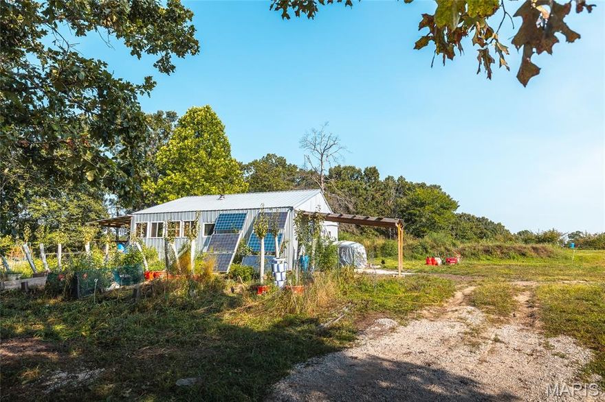 Unique 32x30 off-grid cabin with over 11 acres of unrestricted land perfect for homesteading & self-sufficiency. This property has a rainwater catchment system with gravity-fed water supplying the kitchen sink, bathroom sink, shower/tub & potential washer hookup. The land offers a diverse mix of partial pasture, heavy woods & thinned woods, all fenced on 3 sides with option to raise livestock.  For water & recreation, you’ll find an irrigation pond plus 2 stocked ponds, both with catfish & bluegill, providing both beauty & fresh catches on your land. A small solar setup powers the cabin’s lights, ceiling fans & other essentials, while propane heats the water. There's a generous 6x15 pantry closet to store food. Included with the sale is a wood stove & piping for heat in the cold season. The property has a variety of fruit trees & perennial herbs. Access is easy with Highway VV paved road frontage & a long driveway for privacy. There is a deeded electrical access agreement with neighboring property owners should you wish to connect to the grid in the future. A 4 mile drive to Montauk State Park, known for world-class trout fishing & the spring-fed Current River. The park features crystal-clear waters, lush forests, and scenic bluffs — perfect for photography, nature walks, or just relaxing. Whether you’re looking for a weekend retreat, hunting cabin, or full-time off-grid homestead, this property offers the peace, privacy, and resources to make your vision a reality.