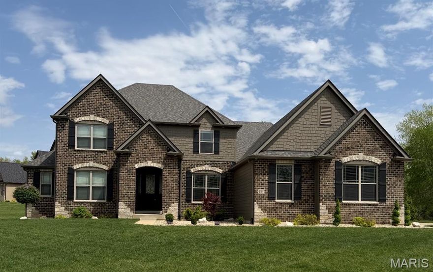 Stunning smart-home–enabled luxury residence on a private .6980-acre lot in the prestigious Bluffs at Windcastle. Features soaring ceilings, expansive windows, and elegant architectural details throughout. Upgraded for comfort with a whole-home air purification system, whole-home humidifier, and in-wall pest control.
The main level includes a dramatic great room with stone-surround gas fireplace and custom built-ins, chef-inspired kitchen with 42” cabinetry, granite countertops, 7’ center island, professional-grade appliances, and wrap-around butler’s pantry opening to a bright breakfast room. Also on the main floor is a private office and luxurious primary suite with coffered ceiling, spa-like ensuite bath with dual vanities, soaking tub, walk-in shower, and large walk-in closet.
Upstairs offers three spacious bedrooms—one with ensuite bath and two with Jack-and-Jill bath—plus a versatile loft. The finished lower level provides a full bar, large recreation space, a room that could be used as a bedroom or office or fitness room, and a full bath.
Exterior features include a level, landscaped yard with full irrigation system and underground electric dog fence, durable Hardie siding, and oversized three-car garage. Located in the award-winning Francis Howell School District with convenient access to shopping, dining, and major highways. Exceptional home in one of St. Charles’ most desirable communities.
Exterior highlights include durable Hardie siding, a level landscaped yard with full irrigation system and underground electric dog fence, and an oversized three-car garage. Located in the award-winning Francis Howell School District with convenient access to shopping, dining, and major highways. Exceptional opportunity in one of St. Charles’ most desirable communities.