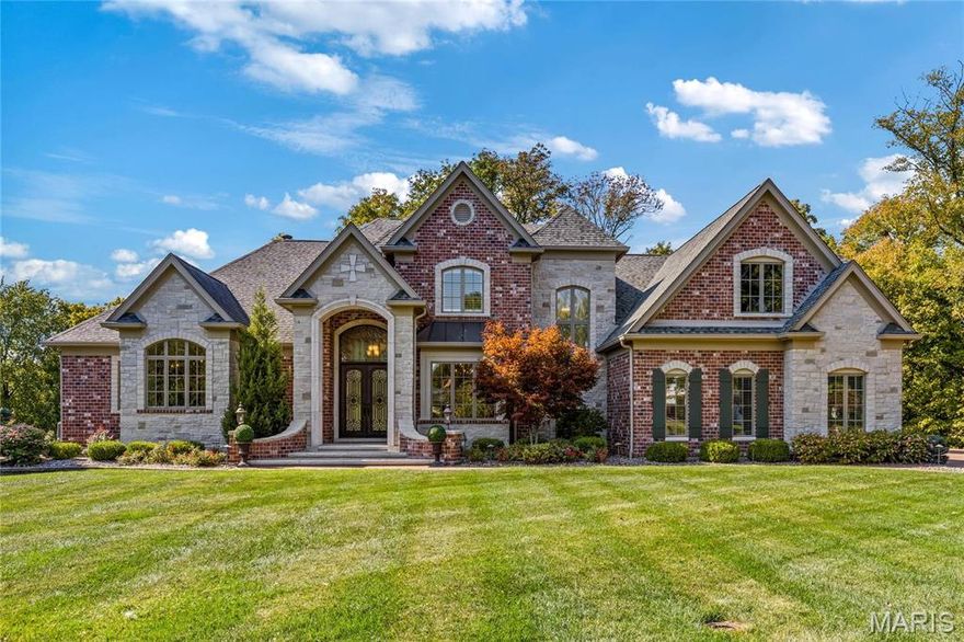 Prominently situated at the end of the cul-de-sac, this Bozich-built Estate home with its dramatic porch entrance with wing walls & 8’ wrought iron double doors makes a stunning entrance. Impressive marble foyer leads to elegant dining room & 2-sty great room with limestone fireplace & soaring windows that overlook the 12th green on the Bellerive Country Club Golf Course. Marc Christian-design kitchen with buff cabinetry, granite countertops, Wolf appliances & 9’ center island adjoins breakfast room, adjacent wet bar & hearth room with floor-to-ceiling fireplace. Coffered primary bedroom suite combines the enjoyment of a marble fireplace with wide bay window, 2 walk-in closets, 1 with laundry, & luxury bath. The 2nd floor extends the living quarters with 4 additional bedrooms & 2 full baths. Lower Level includes media room, fitness studio, sauna, spa-like full bath & guest suite. Atrium doors open to outdoor living room with stone fireplace & 2 patios surrounded by landscaped gardens.
