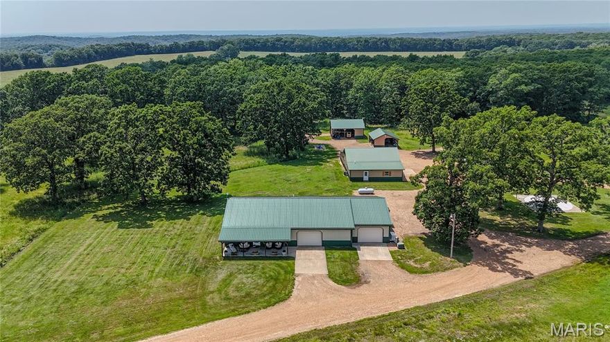 Discover the perfect blend of rustic charm & modern convenience with this stunning 20 acre mini-farm, fully fenced w/ stocked pond. Enjoy peaceful country living from the covered front porch & an outside shower to cleanup after a hard days work. Inside, an open floorplan welcomes you with pine ceilings & a kitchen with oak cabinets & stainless steel appliances. The recently remodeled spa-like bathroom offers a retreat complete with a soaking tub, tiled shower & Bluetooth lighting. The home is equipped with a new Trane XL HVAC system featuring a heat pump, Honeywell electrostatic filter & ionizer, ensuring superior air quality. For ultimate peace of mind, the vented storm room & new whole property generator provide safety during bad weather. The large shop has heat & A/C, concrete floors, 1/2 bath & automobile lift just to name a few perks. Multiple well-maintained shops offer storage & workspace for all your equipment. This meticulously cared for home is ready for you to call home.