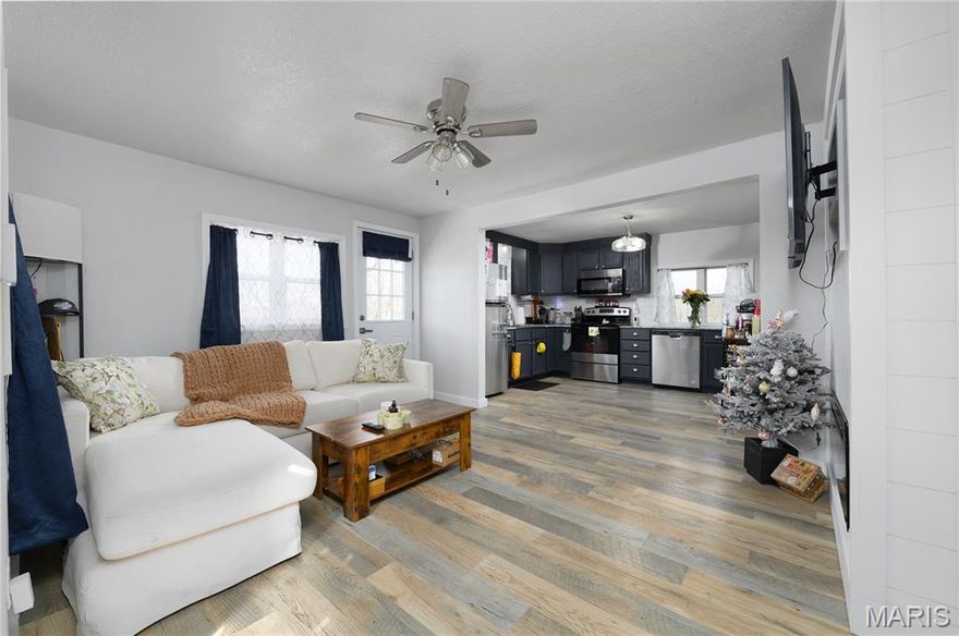 MOTIVATED SELLER. Sitting on over ONE ACRE in a small, historic town in Pulaski County, Missouri, this fully remodeled 2-bedroom, 1-bath home is completely move-in ready. Enjoy the peaceful small-town feel while still being conveniently located between Waynesville/St. Robert, Fort Leonard Wood, and the Lake of the Ozarks.

Inside, you’ll find an open floor plan with waterproof Pergo plank flooring throughout. The beautifully updated kitchen features deep navy cabinets, granite countertops, and a chef-style sink that add character and charm.

Major updates include a 2024 METAL ROOF , recentlyreplaced WATER HEATER 2026 , and 200-AMP electrical service for peace of mind. PUBLIC WATER AND SEWER. The partial basement/cellar offers over 400 square feet of additional storage space.
Relax on the side deck and take in the spacious surroundings, with plenty of room to enjoy outdoor living. The area provides easy access to fishing, camping, and other outdoor recreation, making this the perfect blend of comfort and convenience.