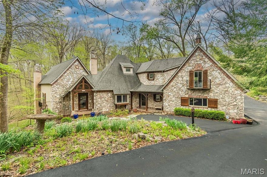 This unique French country home features 5 bedrooms and 6 bathrooms (3 full and 3 half) and was designed by artist John Pils in collaboration with Timberland Design. Set on 3 serene acres of wooded land, this architectural gem seamlessly combines artistry, craftsmanship, and comfort. The home boasts soaring cathedral ceilings, natural pine and red oak details, and thoughtfully crafted elements that reflect the tranquility of the surrounding landscape.
The updated kitchen includes granite countertops and stainless-steel appliances, flowing effortlessly into a breakfast area and hearth room anchored by a stone wood-burning fireplace. A dramatic 2.5-story wall of windows floods the dining room and the adjacent two-story great room with natural light, providing breathtaking views of the property.
The primary suite features cathedral ceilings, two spacious walk-in closets, and a spa-like bathroom complete with dual vanities, a separate shower, and a private water closet. Upstairs, you'll find two more bedrooms, a loft, and John Pils’ hidden study. The walkout lower level offers impressive entertaining space, including a wine bar, a custom wine cellar, a tasting room, two additional bedrooms, and 1.5 baths.
Two screened porches span both levels, creating the perfect setting for enjoying nature, sipping morning coffee, or unwinding with an evening cocktail. Additional highlights of this exceptional property include a mudroom and a 3-car garage, making it a rare offering that balances character and comfort in a private yet convenient location, minutes from the Valley. 64/40 makes this an ideal location, offering a sense of escape from your daily demands. Updates include Brand new septic system sintalled, 8/2025 new pump and drain field, new flooring in upstairs bathroom, main floor half bath and LL half bath, new showers in primary and LL, added stone and split rail fence and lights along driveway, installed retianing rock walls in backyard and along driveway, new asphalt driveway, custom wine cellar, HWH 2022, water softener installed, irrigation system installed, Roof is aprox 11 years.