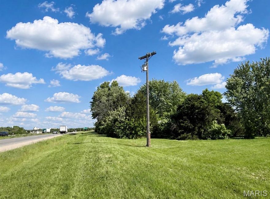 Just under 1 acre with highway frontage, Electric, Water and Sewer on site.  Currently zoned residential and would have to be rezoned to use as commercial.  Property has 2 mobile homes that are condemned but will be removed and a large metal building that can be removed if desired.