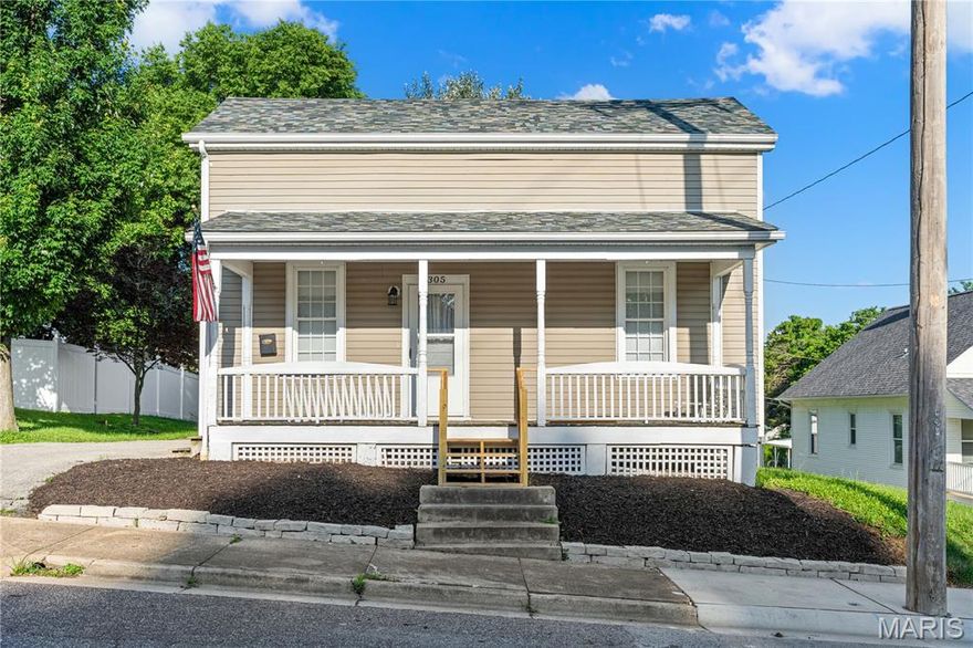 Looking for a New Place to Hang Your Hat?  Here It Is!  Step up on the big covered front porch and into this great house and you will be delighted.  As you enter you'll find the living room to your left and dining room to the right, both sporting gleaming wood flooring.  Kitchen has been nicely updated and offers plenty of natural light.  Main floor laundry is located just off the kitchen and walks out to deck and fenced back yard.  Full bath rounds out the main floor.  Two bedrooms are housed on the upper level along with second full bath and hall closet for storage.  Soft neutral color palette throughout to compliment any decor.  Don't forget the oversized, detached garage.  New roof and gutters, 2026.  Come and see for yourself before it's too late!