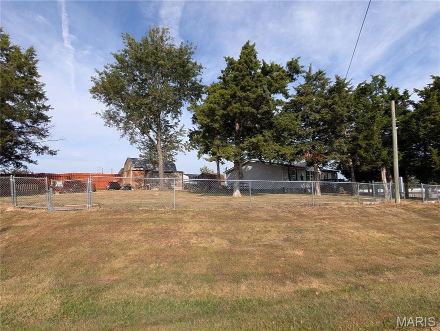 This DBL Lot at the top of the subdivision with nice views, a fenced yard, mature trees, sheds, deck and handicap ramp.  Open floor plan also boasts a fireplace in the dining room!  Most finishes are original and home could use updating.  This is an excellent way to build equity - FAST! -  So bring your Dream of home ownership and make this YOURS!