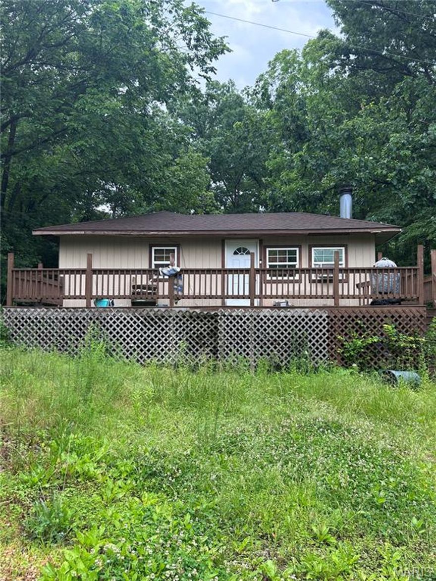 Big Potential on 5.7 Acres!!! Bring your vision and make this split-level home your own! Situated on 5.7 acres with highway frontage, this 2-bedroom, 1-bathroom home offers extra space with potential for more bedrooms. The home features a cozy fireplace, wood and gas heat, and a sprawling front porch perfect for relaxing. A small shed provides additional storage. While the home could use some updates, the setting is full of opportunity—perfect for a mini homestead, weekend retreat, or investment property. Just minutes from town, and all the river fun, plus room to roam. Unlock the potential in this peaceful countryside property!