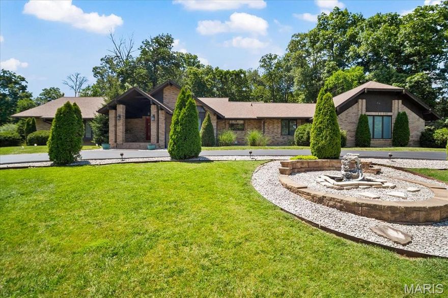 Nestled within the exclusive Meadowbrook Country Club, this beautifully crafted home offers a rare blend of elegance, comfort. From the moment you enter, the inviting floor plan and floor-to-ceiling windows create a sense of warmth and openness, seamlessly combining function with timeless style. The Primary Suite is a true oasis, offering serene views of the expansive back garden. Two additional bedrooms are located on the main floor, along with a full bathroom and a convenient half bath. A third full bath is situated near the pool area for added ease and functionality. The bright dining room is partially separated by modern open shelving and flows effortlessly into the comfortable living room, where you’ll find access to a cozy den/bar area, anchored by a double-sided gas fireplace. The eat-in kitchen opens to a spacious 1,500 sq ft porcelain patio, perfect for enjoying cool evenings or entertaining guests. Just beyond is the 1,700 sq ft indoor pool area, complete with a retractable roof for year-round enjoyment, along with a relaxing hot tub. Downstairs, the expansive lower level is accessible via the main foyer, rear staircase, or private elevator. It includes a second kitchen, two additional bedrooms, a dedicated office, and a media room ideal for movie nights or watching the big game. The basement walks out to the side yard and offers generous storage throughout. This truly special property blends luxury and lifestyle in a premier location— a must-see home.