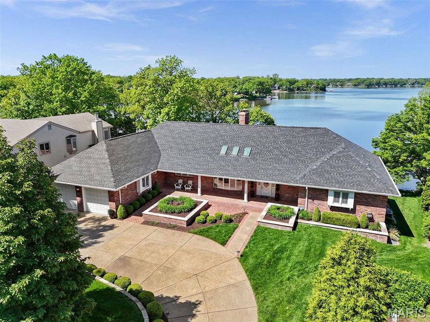 Custom-built by renowned builder Bob Whittaker for his own family, this extraordinary waterfront full brick home offers breathtaking panoramic views of Lake St Louis from nearly every room. Crafted with timeless design & thoughtful detail, it features a heated saltwater pool, screened patio, lighted deck & 2 private boat slips, perfect for lakeside entertaining. Inside, livable luxury awaits with a chef’s kitchen boasting Wolf professional-grade appliances & gorgeous custom cabinetry. Sunken great room w/see-through stone fireplace, 4-season room & an elegant primary suite w/spa-like bath highlight the main level. Invite friends to gather in the spacious walkout lower level rec room w/wet bar. 3-car tandem garage w/heated workshop, zoned HVAC & updated roof. Nearby LSLCA’s resort-style amenities include pools, golf, clubhouse dining, tennis & more. Served by Wentzville (Timberland) schools, this prime location offers an unmatched opportunity for luxury lakefront living. See it today!