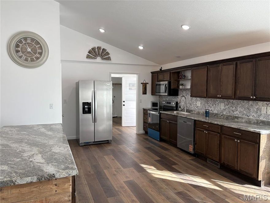 Fully Renovated, Fully Furnished Modern Showpiece on Quiet Dead-End Street! Completely remodeled 3Br/3Ba brick home with open floor plan offering 2,136 sq ft on .56 acres in Poplar Bluff. Nearly everything is new-roof, windows, wiring, insulation, sheetrock, flooring, central heat & air, kitchen, bathrooms, and brand-new appliances. Spacious open-concept layout features a large living room and oversized bar ideal for entertaining. Stunning kitchen includes modern finishes & walk-in-pantry. Dedicated laundry room adds convenience. Primary suite offers double closets and a double vanity. Secondary room includes a walk-in-closet, and third bedroom features a large closet for excellent storage. Bright sunroom provides flexible space for office, bonus room, or potential 4th bedroom. Exterior highlights include classic brick with minimal vinyl, new deck, one-car-garage, storage shed, and peaceful setting on a low-traffic dead-end-street. Zoned for O'Neal elementary/Poplar Bluff Schools. New furniture stays (bedding and decor excluded) Truly move-in ready --all the work has been done.