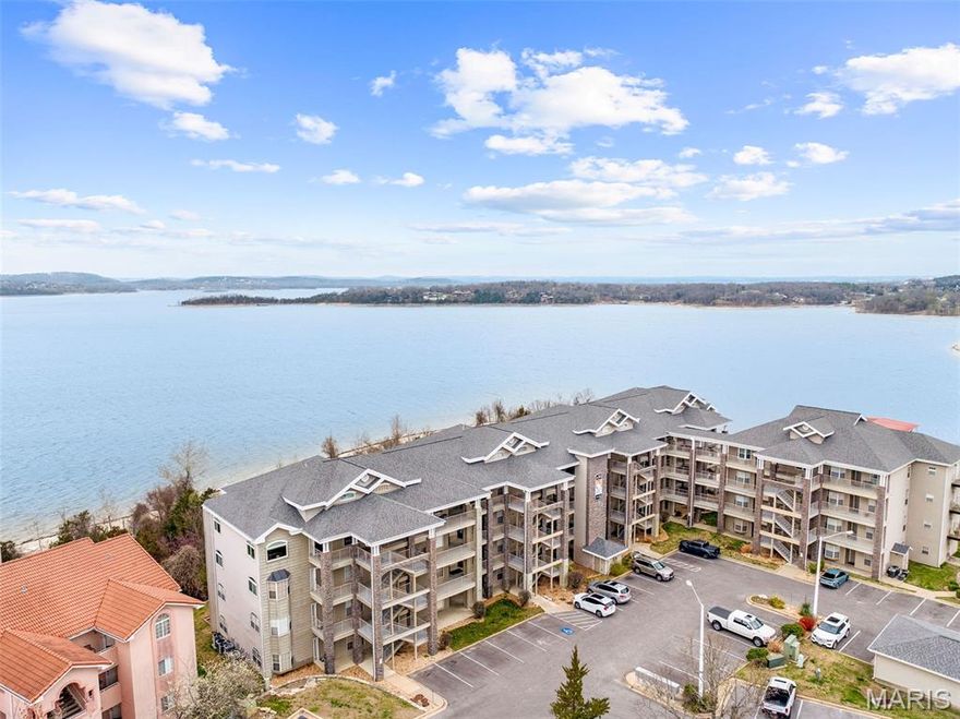 LUXURY LAKEFRONT LIVING -- WALK-IN, NO STEPS, Ground Floor Condo. Welcome to lake life at its absolute finest--where every day begins with the soothing sounds of water gently lapping the shoreline and ends with breathtaking sunsets over Table Rock Lake. Step in this beautifully maintained, ground-floor walk-in condo and immediately feel the difference. Located in The Towers within the prestigious, gated community of Emerald Pointe, this residence offers effortless access to the lake, just steps from your door. The spacious open floor plan provides a comfortable spaciousness, while the four-season room and rare outdoor patio create an exceptional indoor-outdoor living experience that truly sets this property apart. The chef in you will delight in the brand new stainless appliances and gorgeous new flooring throughout. The luxurious primary suite features french doors, double vanities, and a relaxing jetted tub, while tray ceilings, recessed lighting & ceiling fans add elegance throughout. This condo is being sold fully furnished with newer, high-quality furnishings, making it completely move-in ready. Lake enthusiasts will love the convenience marina with high and dry storage, courtesy dock, and boat ramp next to the condo. Residents of Emerald Pointe enjoy resort-style amenities including two swimming pools, a clubhouse w full kitchen and meeting space, a fitness center, and tennis/pickleball/basketball courts, all within a secure gated setting. Perfectly positioned between Table Rock State Park Marina & Top of the Rock, and located across from Battleship Point--home to the popular jumping cliffs--this location offers both peaceful relaxation and easy access to adventure. You are also just minutes from world-class golf, dining, shopping, medical facilities, and the stunning Thunder Ridge Nature Arena. This is more than a condo--it's a lifestyle, offering the perfect blend of luxury, convenience, and natural beauty.
