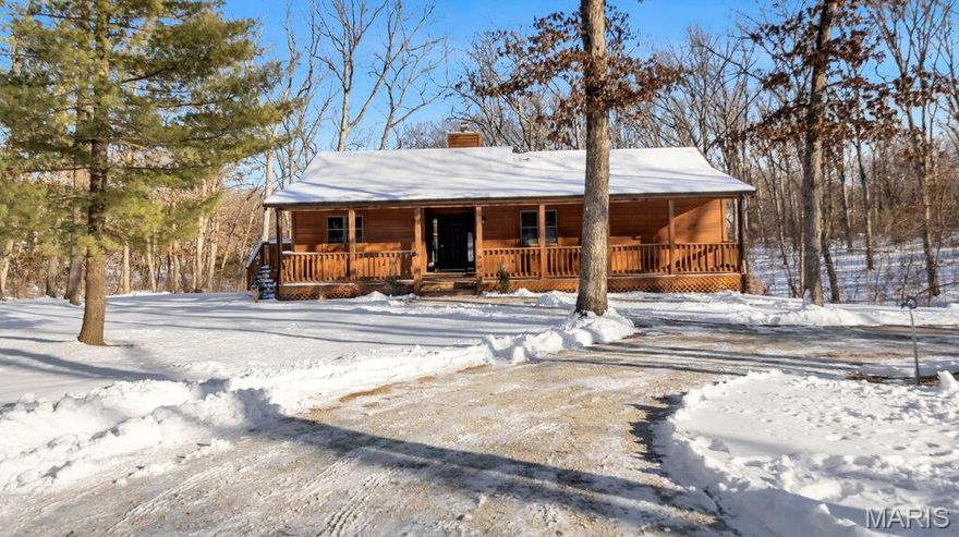 Nestled on 1.63 acres, this charming updated cedar ranch offers the perfect blend of privacy and comfort. The large covered front porch leads into an open floor plan with a vaulted ceiling, a cozy wood burning fireplace, gorgeous laminated Pergo wood floors and lots of natural light. The kitchen has updated appliances, new light fixtures and a large island. Step outside to the expansive new deck that covers the entire length of the house. The primary bedroom has a full bath, walk-in closet and French doors lead out to a covered portion of the deck with peaceful wooded views perfect for relaxing. There is a second bedroom and renovated full bath (all new plumbing, flooring and custom tiled shower) on the main level. The walkout lower level offers a 3rd bedroom, large rec room, plumbing rough-in, new ceiling and lots of extra space. The laundry room has all new plumbing and drywall. New R-19 insulation, new water heater and softener, new landscaping and new gutter screens. High speed Spectrum fiber is a bonus if you work from home.  Enjoy this rustic retreat with tons of wildlife and nature year round !!!!  Home is being sold AS-IS.