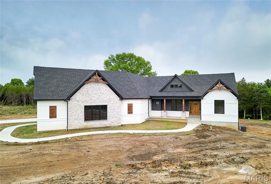 Luxurious living in a country setting all on a 5 acre unincorporated lot! This stunning custom built home includes full brick & stone elevation, side entry 3 car garage, 5 bed, 3.5 bath, open floor plan concept home, partially walk out finished LL, floating wood floors, black frame windows & vaulted ceiling throughout the dining, great room, kitchen & breakfast room. Enjoy entertaining in the spacious dining room & relaxing in the bright great room w/ floor to ceiling windows, custom stone electric fireplace & open staircase. Custom kitchen features pendant lighting, granite counter tops, dark custom cabinetry, custom range hood, dual wall ovens, SS appliances & bright breakfast room overlooking your covered deck area and private backyard. Master suite features coffered ceiling, huge walk in closet, custom over sized tiled shower w/dual heads, soaking tub, dual sink vanities & recessed lighting. The walk out LL offers 1,384 finished sqft with a stunning full brick & stone custom wet bar w/pendant lighting, granite counters, floating wood flooring & carpet. Bedroom and full bath complete the LL. Enjoy nature and serenity at its fullest with this beautiful property. NO HOA to deal with on this unincorporated stunner and adjoining 4.5 acre lot can but purchased for more land and privacy. See MLS # 26029175 SELLER TO OFFER $10,000 CREDIT TOWARDS RATE BUY DOWN OR BUYERS CONCESSIONS!