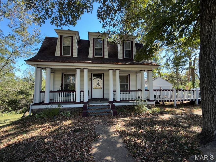 Absolutely charming Dutch Colonial Revival home offering timeless character and inviting curb appeal. Featuring 3 bedrooms, a sleeping area in the lower level, and 3.5 baths, this home blends classic architectural details with comfortable living spaces. The covered front porch with its stately columns welcomes you inside, where you’ll find warm, inviting rooms filled with natural light. The distinctive double-sloped gambrel roof and dormer windows add to the home’s historic charm. The kitchen is cozy and functional, complete with a breakfast bar, and the beautiful staircase leads to the upper-level bedrooms and full bath. The mostly finished lower level provides incredible additional living space, including a brand-new full bath, sleeping area, living room, and dining are perfect for guests or extra privacy. Outside, a spacious 2-car detached garage is a wonderful bonus, along with the classic stonework and touches of original character around the property. Set on a corner lot with a gorgeous backdrop, this home offers a truly picturesque setting. A must-see to fully appreciate its beauty and charm, all situated in the Awsome Arcadia Valley where you are just minutes from Elephant Rocks and Johnson Shut-ins State Parks, along with the beautiful Black River which is also nearby At K Bridge Annapolis and Lesterville areas for floating and recreation. Arcadia Valley is a very charming area.