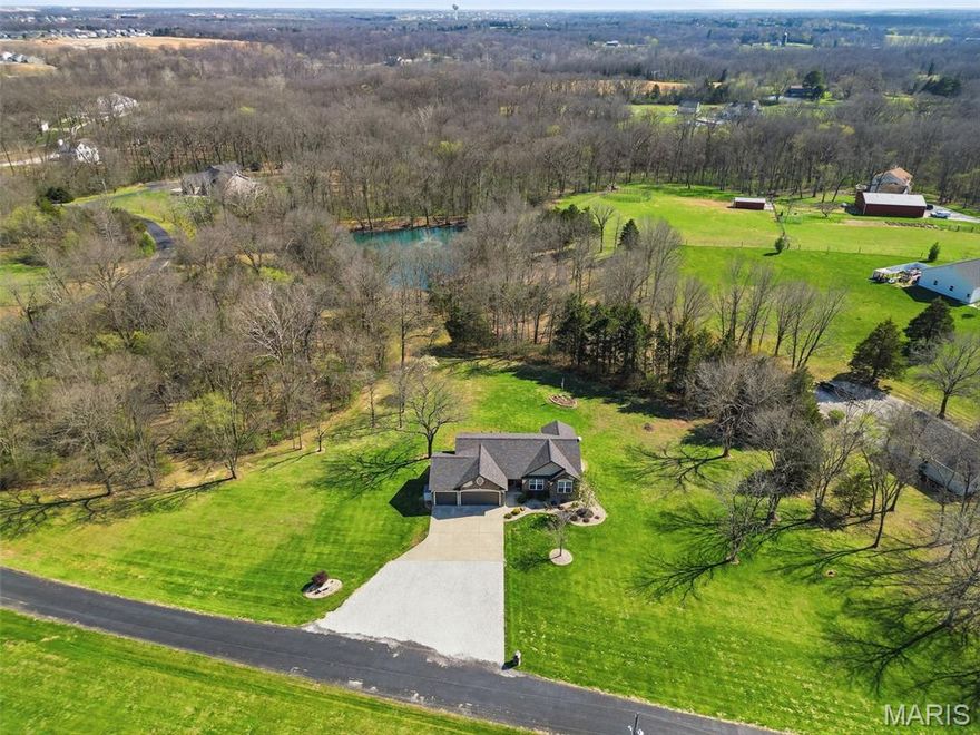 Beautifully maintained Ranch home on 4.5 Acres with a 3 car garage and an Outbuilding! Located on a quiet street in Unincorporated St. Charles County with easy access to both Hwy 70 and Hwy 61, this 4 bed 3 bath home is better than new.  Three bedrooms and two full baths on the main floor, including a very spacious master bedroom. The Open kitchen/dining room flows right into the large living room and a beautiful back deck overlooks the very private back yard.  The Walkout basement features a huge recreation area with bar, a media room, additional bedroom and full bathroom, and plenty of room for storage. The 40x30 outbuilding has room for all your toys, tools and projects and there is plenty of room for storage in the 2nd floor loft. This sprawling 4.5 acres creates a ton of privacy and even fronts on small shared pond. Come see this immaculate home and see everything this property has to offer.