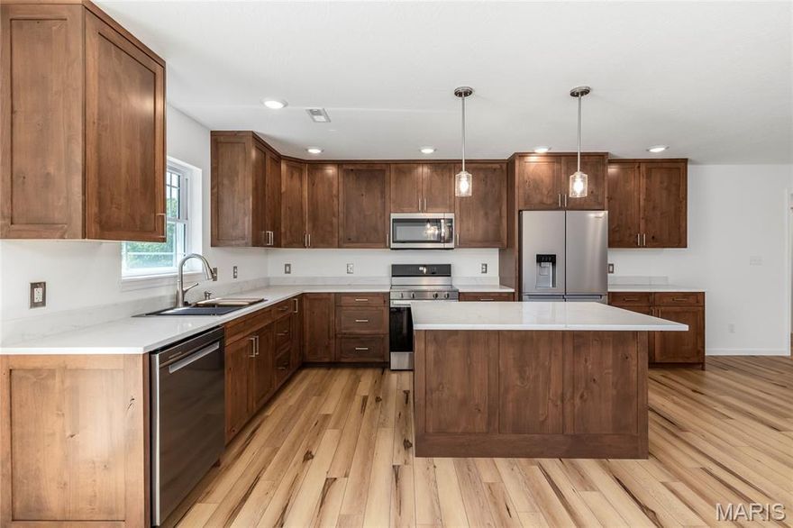 This brand-new 4-bedroom, 2-bath home sits on nearly 2 acres within the city limits, offering the perfect blend of space and convenience. The corner lot provides plenty of room to enjoy, along with a 2-car garage for added functionality. Step inside to an inviting open living and kitchen area, complete with custom cabinets, neutral paint tones, and stylish flooring that create a warm, modern feel. The split-bedroom floor plan offers privacy, featuring a spacious primary suite with a walk-in closet, making it a comfortable retreat to come home to. With its thoughtful design and generous lot, this home is the perfect place to enjoy both comfort and room to grow.