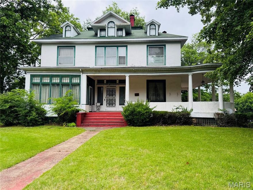 Step into a piece of Poplar Bluff history with this stunning 1892 Queen Anne style home offering over 4,000 sq. ft., 3 bedrooms, and 2.5 baths filled with timeless charm and unforgettable character. From the expansive wraparound porch to the intricate original details throughout, this home offers craftsmanship and history that simply cannot be recreated today. Inside you’ll find beautiful parquet floors, soaring 10- and 11-foot ceilings, original coal-burning fireplaces, pocket doors, stained glass, gingerbread fretwork, leather wallpaper, and oversized 10-foot doors. The formal dining room even features a serving window designed to open to the outdoors for entertaining and parties. Additional historic touches include a breakfast room, upstairs smoking parlor, steam radiant heat, and remarkable architectural details around every corner. During both World War I and World War II, bandages for the Red Cross were rolled in the basement, adding another meaningful chapter to this home’s incredible story. The stained glass above the front door was commissioned by the artist who restored the glass in the Poplar Bluff Methodist Church. Lovingly maintained and well cared for over the years, this home is more than a property; it’s an opportunity to own a true piece of history. If you’ve dreamed of owning a historic showplace with unmatched character, craftsmanship, and a story to tell, this is one you must experience in person!!
