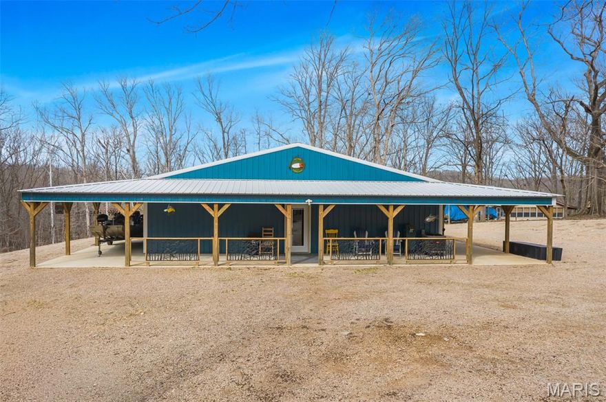 If you've been dreaming of the Ultimate Lake Experience, your dream just came true at 35 Cozart Cove!  Custom built in 2024, this 1400 square foot Lake Home is perched high above Lake Wappapello, offering breathtaking views and endless outdoor recreational bliss in every direction.  A ten foot wide, wrap-around porch provides the perfect place for socializing, cook-outs, celebrations, or just peaceful relaxation.  The rustic interior comes fully furnished, complete with high-end finishes like granite countertops, stainless appliances, upscale barstools, custom cabinetry, beautiful flooring that is easy to maintain, a luxuriously spacious bathroom, separate laundry space, large bedrooms with custom-built rustic furniture, a climate controlled environment - lots of attention to detail, comfort, efficiency, and relaxation!  

With a private road maintained by the Corps of Engineers, you can easily drive down to the Boat Slips, one of which you as the new owner would share with another resident.  Once there, literally cast your cares out onto the water, and begin making memories so precious that you'll never want to leave!