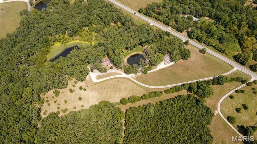 This home and property is an absolute MUST SEE! This property is just shy of 8 acres with a massive 36x60 shop and detached oversized 2-car garage. As soon as you turn into the driveway, the first thing you'll notice is the blacktop paved drive with serene views of your fenced in pastures, well-maintained lawn and beautiful lake views. This full brick home features 4 bedrooms, 2 bathrooms, full finished basement, covered back deck, custom woodwork accents throughout and much much more. Just a couple minutes from town and off a well-maintained state highway. As soon as you step inside, you'll notice the open foyer with custom atrium style island to welcome all of your future visitors, hand crafted stairwell banisters and rails, wood burning fireplace made of all stone, eat-in kitchen with stainless steel appliances and so much more. Downstairs you will find a recreation room, kitchen, tanning room, bedroom and full bath. The shop is partially insulated and features propane heat, 12-foot automatic overhead doors, 1/2 bath and is on its own electric meter and septic to be completely self-contained. This property has too much potential to list. Rather you are looking for the perfect mini farm with a great location or an easy to maintain home with custom features, then this is the home for you. Schedule your showing today!