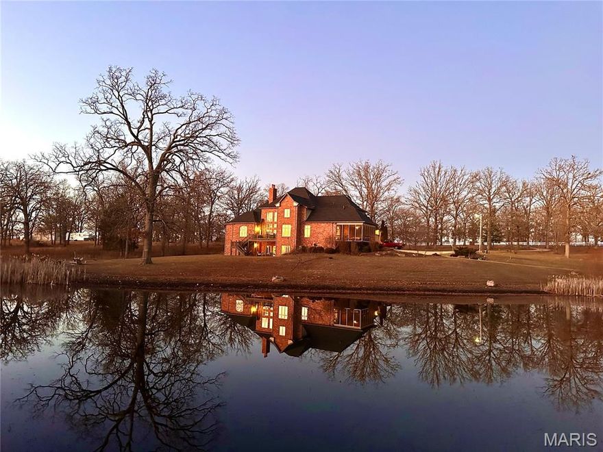 This is the one! 5 beds, 4 1/2 baths. 6,836 sq. ft. of finished living area on 3 floors. Full brick with luxurious primary on main level. Enjoy 3 fireplaces, miles of custom millwork, a chef's kitchen featuring custom cabinetry, 3 dish washers, Wolf cooktop and double oven, 48" SubZero, granite countertops, a breakfast bar, wet bar, butler's pantry, walk-in pantry, a library and separate formal dining. The upper level includes an additional private suite with attached full bath and the 2 additional bedrooms share a jack-and-jill bath, and a craft room with built in cabinetry. The upper floor office has built-in shelving and features an L-shaped desk overlooking the scenic outdoor view through the cat walk. The finished space over the garage has endless possibilities. The lower level has an oversized suite with private bath, a den with double French doors to the lower patio and another bonus room. Additional unfinished space makes storage a breeze. This dream home overlooks two ponds with an overflow waterfall feature beneath the walk-bridge.  Abundant wildlife, oversized 3 car garage. New roof with transferrable labor and shingle warranty completed 8/14/2025. Perfect for a corporate retreat with 3 bedroom suites. Close to the Ozark National Scenic Riverways and only two hours from St. Louis.
Broker owned.