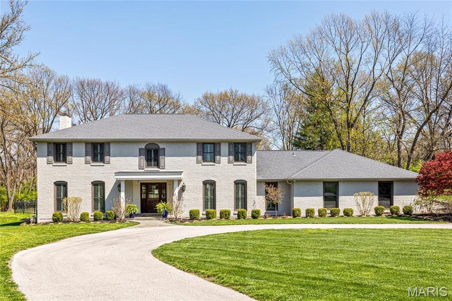 This stately full-brick 2-sty Colonial features distinctive design elements & extensive updates throughout including detailed trim work, plantation shutters & oak hardwoods that extend throughout the main living area.  Impressive foyer leads to formal living & dining rooms with full-height windows and spectacular family room with wet bar & floor-to-ceiling brick fireplace flanked by built-in bookcases. Culinary enthusiasts will love the designer kitchen with white Shaker cabinetry, quartz countertops, commercial grade appliances, 9’ peninsula & butler’s pantry. Adjoining breakfast room with wide bay window & a convenient office complete the main floor living quarters.  Oak staircase accesses redesigned primary bedroom suite with customized walk-in closet & luxury bath with freestanding tub plus 3 additional bedrooms & hall full bath. Lower Level includes recreation room, game room with wet bar & ½ bath. Situated on a tree-lined 1+ ac lot with patio, pavilion, pool & 3-car garage.