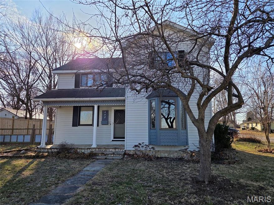 Step into timeless character and modern comfort in this historic 1910 corner-lot home filled with charm and space. This 3 bedroom 2 bath beauty features many trey ceilings, and a welcoming, covered stone front porch. As you enter the home, you are greated with charm and warmth from the beautiful chandelier. The cozy living room boasts a bay window and lots of natuaral light. The formal dining area adjoins the living room and has endless possibilities. A spacious eat-in kitchen with a wood accent wall, mostly stainless appliances, and ample storage space adds to this homes perfection. The primary bedroom  and en suite is on the main level. Two more large bedrooms upstairs as well as a bonus room that has endless potential. It's currently designed as a guest space but has a removable wall so the entire space could be opened up. This property has a privacy fence around the spacious backyard, some vinyl, some wood, as well as a wood & metal regular fence, a flagstone path leads from the house to the detached garage,  2nd bathroom and separate laundry room is also on the main level. This historic home is ready to be a family home or would make a great investment opportunity as a vacation rental. Pictures don't do it justice. Schedule an appointment today to see this beauty in person.
