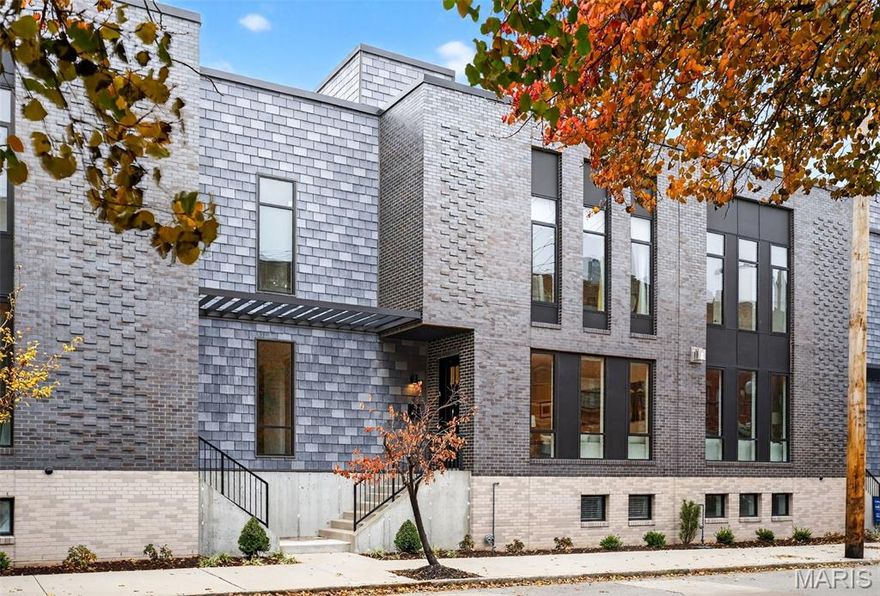 Welcome to the Artizen on West Pine Townhomes — where modern design, chic style, and effortless city living come together. Built in 2023, this contemporary townhouse showcases soaring ceilings, wide-plank wood flooring, expansive picture windows that flood the home with natural light, and high-end designer finishes throughout. The spacious formal living room welcomes you in and flows seamlessly into a stunning chef’s kitchen featuring sleek cabinetry, an upgraded tile backsplash, an oversized quartz island, and top-tier stainless steel appliances. An additional open living area just beyond the kitchen provides the perfect flexible space for lounging, entertaining, or creating your ideal setup. Upstairs, the primary suite impresses with its generous walk-in closet, a spa-inspired bathroom with a floating dual-sink vanity and glass shower, and a private balcony — your perfect spot for morning coffee or evening wind-downs. A secondary bedroom with a custom walk-in closet, a full bath with a tub/shower combo, and a dedicated laundry closet complete this level. The top floor is designed for entertaining, featuring a wet bar with a beverage fridge and a PRIVATE ROOFTOP TERRACE — an incredible urban oasis with room to gather, unwind, and take in the surroundings. The finished lower level adds even more versatility with an additional bedroom, full bathroom, and an oversized two-car garage with great storage options. The garage leads to a private, gated drive court shared by residents. With exceptional space, thoughtful design, and an unbeatable location, this townhouse offers the ultimate blend of luxury and vibrant city living. All within walking distance to the Cortex, IKEA, BJC and the best of the Central West End and a short drive from SLU!