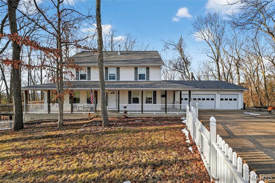 Welcome Home to this private retreat nestled on nearly 3 wooded acres in the heart of House Springs Missouri. This stunning 2-story offers the perfect blend of peaceful seclusion and everyday functionality with a balance of comfort and style. With 4 bedrooms, 3 full baths, and over 2,400 square feet of living space, this home delivers space to spread out while maintaining a warm, inviting feel throughout. An additional Finished Bedroom is in the basement with a walkout to the scenic backyard and finished retaining walls.
A classic covered front porch that wraps around the side and back, welcomes you in, setting the tone for relaxed country living. Inside, the main level offers comfortable gathering spaces ideal for both daily life and entertaining. Large windows bring in natural light and frame serene views of mature trees surrounding the property. 
The spacious kitchen flows easily into dining and living areas, creating a seamless layout for hosting family and friends. The long enclosed sun porch creates an inviting extension of the living space, perfect for morning coffee or evening conversations for many to share.
Upstairs, the generously sized bedrooms provide flexibility for growing families, guests, or a home office. The primary suite offers privacy and comfort with an en-suite bath.
Step outside and enjoy the true highlight of this property — 2.87 acres of owned-wooded land that adjoins additional privately owned land, enhancing the sense of seclusion and privacy. Whether you’re envisioning a garden, outdoor entertaining space, play area, or simply enjoying quiet mornings outside, this setting offers endless opportunity.
Additional features include a 3-car garage, ample driveway parking, and a layout designed for both function and flexibility. The exterior also features extensive landscaping. Location could not be better – close to major highways, restaurants, shops, schools including the Northwest Valley elementary school, a well sought after staple of education this home qualifies to attend.
If you’ve been searching for acreage, privacy, and a home that feels like a retreat — all while staying conveniently located to central shopping and dinning — this is the one.