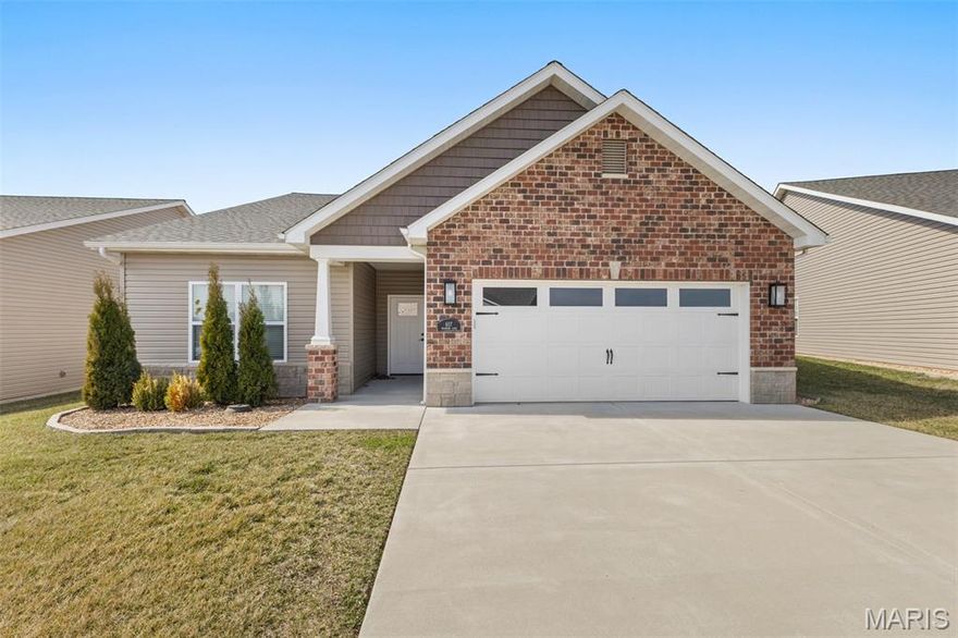 If you have finally realized that owning a lawnmower is a lifestyle choice you no longer wish to make, this three bedroom and two bath villa is your way out. It is designed for anyone who wants the home and the attached garage without the endless weekend to-do list. With lawn care and snow removal fully handled for the entire community, you can spend your winters watching a professional crew clear the street while you stay inside where it is warm.

The interior is centered around a living room with vaulted ceilings that make the entire home feel incredibly spacious. This area opens directly into a kitchen featuring a massive island. It is the perfect spot for laying out a spread of food or just leaning against while you wait for your coffee to brew. Everything is clean and modern, which leaves you with more time to do literally anything other than home repairs.

The primary suite is built for anyone who is tired of sharing their personal space. The bathroom features a double vanity so you can have your own sink and your own peace of mind. You also get a walk in closet that can actually fit your entire wardrobe without a struggle. The two additional bedrooms are available for guests or a home office for the job that pays for this maintenance free lifestyle.

When you want to enjoy the outdoors without the work, you can head out to the concrete back patio. It is the ideal spot for a grill or some comfortable chairs where you can sit and appreciate the fact that you are not the one trimming the hedges. There is also a community pond with a paved sidewalk that loops the water for when you need a scenic stroll. Since the neighbors also have their maintenance handled, you can all enjoy the view together without a single lawnmower in sight. If you are ready to stop spending your free time on manual labor, this villa is the move.