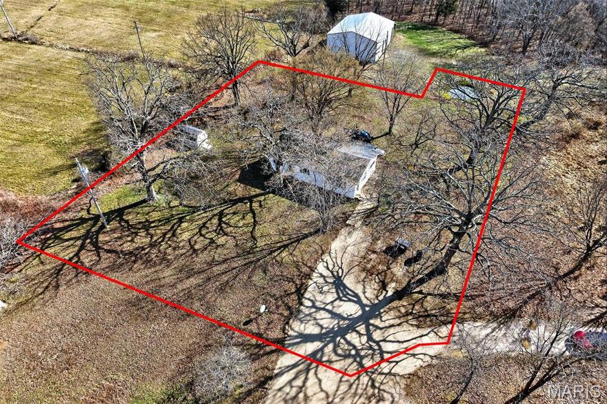 This tidy 2 bedroom, 1 bath home offers cozy country living on a budget!  Sitting on .91 acre, the 1,125 sf home has vinyl siding and HVAC that is less than a year old! The rooms are spacious and the setting is quiet and peaceful.  The kitchen features a large picture window above the sink and includes a dishwasher, range, and refrigerator, making your move-in easy and affordable. A sliding back door leads to a covered porch perfect for relaxation.  This place is ready for new owners and will make a great home for YOU!