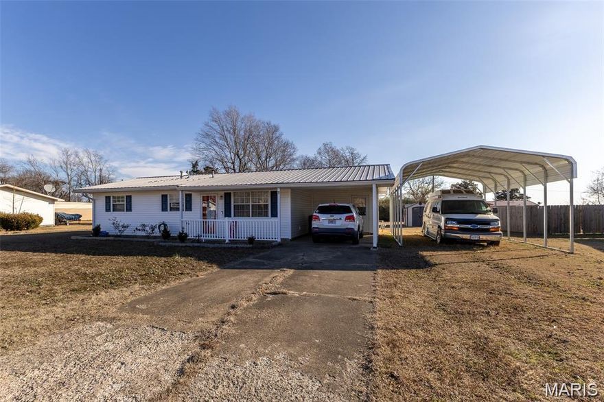 This cozy 2-bedroom, 1-bath home offers comfortable living with thoughtful updates and practical spaces throughout. Located just outside city limits with no restrictions, you’ll enjoy the freedom and flexibility of country-style living while still having easy access to the highway for convenient travel. Step inside to a welcoming living room, creating a warm and comfortable place to relax. The kitchen features newer vinyl plank flooring and a functional kitchen-dining combo, making the most of the home’s practical layout. Both bedrooms offer comfortable spaces, and the convenience of main-level laundry adds to the home’s easy everyday living. Recent improvements include new siding(2023), a new storm door (2022), a new water heater (2025), and added blown-in attic insulation(2023) for improved energy efficiency. The home also features a durable metal roof and a newly updated front porch railing that adds charm to the entrance. Outside, the private backyard provides room to enjoy the outdoors with space for chickens, a greenhouse, two outbuildings, a catio, and a pet fence for small dogs. An attached carport plus an additional RV carport offer plenty of covered parking. Perfect for those looking to downsize or enjoy a simpler lifestyle, this thoughtfully updated home offers comfortable, practical living in a peaceful setting. Property qualifies for lender paid 1-0 buydown via Envoy mortgage.