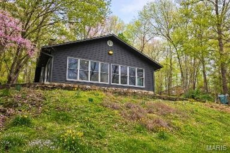 Waterfront Home on the Eleven Point River – Gatewood, Missouri
Enjoy peaceful riverfront living in this charming 2 bedroom, 1 bath home located on the beautiful Eleven Point River in Gatewood, Missouri, in Oregon County. With 1,632 square feet, this home offers a spacious and inviting layout featuring both a living room and a separate family room, perfect for relaxing or entertaining.
The home features an open-concept design with a U-shaped kitchen complete with custom wood cabinets and laminate countertops, offering both functionality and warmth. A dedicated laundry room adds convenience, and the large bathroom provides plenty of space.
Features include durable Hardie siding, central heat and air, gutters, a decorative gas heating stove, and a wood-burning stove set on a stone hearth built by Amish craftsmen. Across the entire front of the home, smart sun heat-reflective glass windows showcase stunning river views while helping with energy efficiency.
Outdoor enthusiasts will love the shared private boat ramp for two families, easy access to the river, and the property’s location just 5 miles south of the Missouri Scenic Riverways. A storage shed adds extra convenience, and the surrounding area is rich with wildlife including deer, turkey, otter, and mink.  Enjoy the beautiful Eleven Point River fishing, floating or boating experiences.
This is a wonderful opportunity to own a scenic river home perfect for a full-time residence, weekend getaway, or vacation retreat.