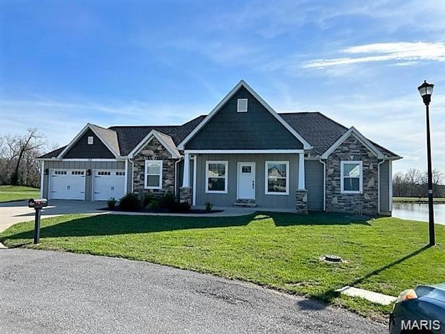 Like-new, one-owner ranch home situated on a quiet cul-de-sac with picturesque lake views. This 4-bedroom, 3-bath home offers a spacious open floor plan designed for effortless entertaining. The light-filled main level flows seamlessly to a covered deck where you can relax and take in stunning sunset views over the lake. The finished lower level provides additional living space and includes a large John Deere room, perfect for extra storage or hobbies. A rare combination of peaceful setting, thoughtful layout, and pristine condition—this home is truly move-in ready.