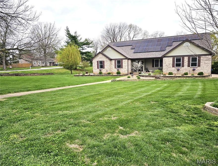 Discover the perfect balance of elegance and comfort in this meticulously maintained atrium ranch, perfectly situated on a sprawling corner lot in the desirable Pearl Ridge subdivision. From the moment you step into the light-filled foyer, you are greeted by soaring vaulted ceilings and an expansive great room that defines open-concept living. The heart of the home features a chef-inspired kitchen boasting a center island, premium solid-surface countertops, and a walk-in pantry, all flowing seamlessly into a cozy hearth room anchored by a warm custom-built fireplace. Retreat to the main-floor primary suite, a private sanctuary complete with a luxury bath featuring a whirlpool tub, separate shower, and double-sink vanity.
The living space extends far beyond the main level with a massive walk-out basement that has been thoughtfully upgraded to include a full private mini-suite. This versatile addition features its own functional kitchen and comfortable den, making it an ideal setup for an in-law suite, guest quarters, or a premium entertaining hub. With this addition, the home offers over 4,200 square feet of total finished area, providing ample room for multi-generational living or a dedicated home office. Outside, the nearly 0.7-acre level lot backs to peaceful common ground, providing a private backdrop for entertaining on the deck or patio. The exterior curb appeal is equally enchanting, highlighted by a tranquil koi pond near the front entrance that offers a serene welcome to every guest.  Complete with a side-entry oversized garage, an in-ground sprinkler system, and a location within the prestigious Francis Howell School District, this home offers a rare combination of sophisticated style and everyday functionality.  This home has so much to offer.  It's a must see!!