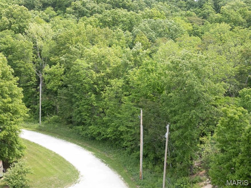 Welcome to 40 Winding Lane, Troy MO. - A Slice of Country Paradise! Nestled in the heart of Western Lincoln County, this beautiful 3.01-acre wooded lot offers the perfect setting for your dream home. Enjoy the peace and privacy of country living while still being just minutes from the conveniences of Troy. This property features a heavily wooded landscape, providing natural beauty and seclusion. Minimal HOA restrictions allow for added flexibility, including zoning that permits one horse per 2-acres, an existing wooden barn is included and being sold as-is, offering potential for refurbishment and a variety of future uses.
Electric is available at the property line, while septic and well will need to be installed. Whether you’re ready to build your dream home or invest in land for the future, this property offers flexibility, charm, and endless potential. Take a scenic drive out to the county and discover the possibilities at 40 Winding Lane—this hidden gem won’t last long!