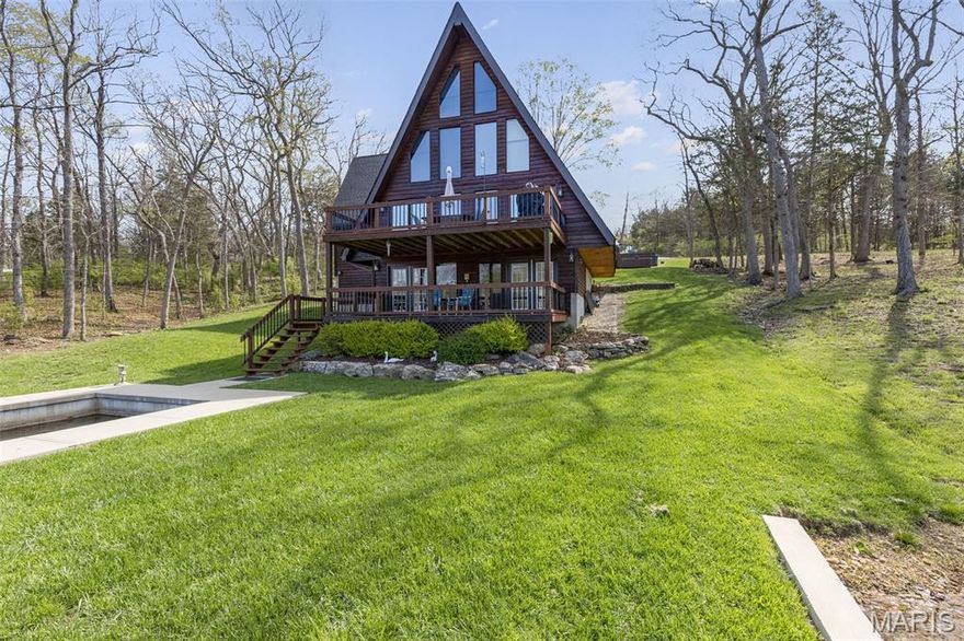 RESORT STYLE LIVING IN THIS BEAUTIFUL WATERFRONT PROPERTY.  From the minute you step inside this home you know it is someplace special, its where memories are made.  Imagine sipping your morning coffee from the deck while appreciating the tranquility that comes from being near the water.  Or enjoy a glass of wine from the covered porch as friends settle in after a long, laughter-filled day of boating.  Entertaining family is made easy with the large kitchen complete with breakfast bar and plenty of countertop space.  Spacious dining room is open to the kitchen so the cook never feels left out of the conversation.  The WOW factor is in the floor to ceiling wall of windows in the great room where you can admire an incredible panoramic view of the lake.  Finished walkout basement provides the perfect amount of privacy for visitors with sleeping rooms and dedicated family room with huge wet bar.  The real fun begins at the water's edge at the private boats slip and sundeck(new seawall in 2022) where you can wet-a-line or catch some rays. Other impressive features include:  hardwood floors, ceramic tile flooring, stainless appliances, main floor laundry, central vacuum system, wood burning stove, cedar lined closet, his-and-her closets, separate water closet, powder room, luxury vinyl plank flooring, dual hot heaters and jet-tub.  This home has been meticulously maintained down to every detail including the updated AC and roof.  This home is located on the 120+/- acre big lake in the sought after Raintree Plantation neighborhood.  This is a gated community where you can enjoy the 18 hole golf course, country club, pool and beach.  Drive through the gate of this neighborhood and you will see and feel the difference this neighborhood has to offer.  Living on the waterfront at Raintree is a lifestyle.  CALL TODAY TO TAKE A LOOK INSIDE!