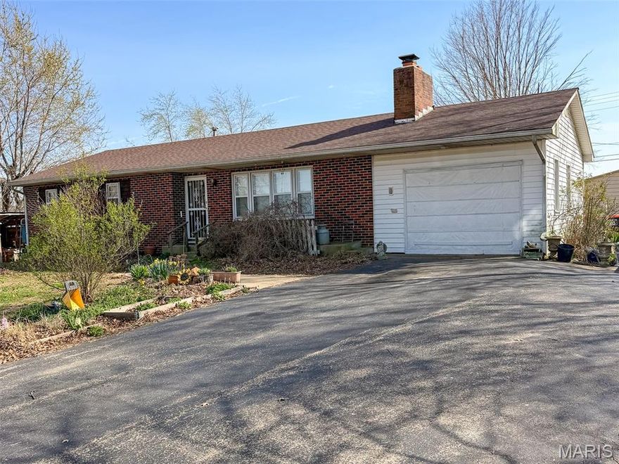 Charming brick home on .57 acres with 1,272 sq ft. Beautiful hardwood floors, a cozy fireplace, and a full basement offering plenty of storage or potential for additional living space. The well landscaped yard comes alive with flowers each spring and includes a garden and greenhouse. The property also features a large shop and two sheds (10x20 and 12x40, one finished), along with space for animals. Perfect for anyone wanting a little room to spread out while still being close to town.