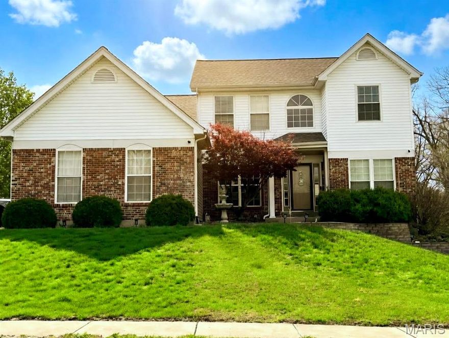 Nestled on a premium corner lot in the desirable Emerald Forest community, this beautifully maintained two-story home offers exceptional curb appeal and thoughtful landscaping. Step inside to a welcoming center hall floor plan featuring rich wood flooring and elegant formal living and dining rooms.  The open-concept kitchen and family room are truly the heart of the home, showcasing an expansive updated kitchen with stainless steel appliances, granite countertops, tile backsplash, breakfast bar, and built-in desk area. A convenient drop zone/locker space and main-floor laundry add everyday functionality. The inviting family room features custom built-in bookcases, a stunning five-bay window, and a cozy wood-burning fireplace. Upstairs, the spacious primary suite boasts vaulted ceilings and a luxurious en suite bath with double vanities, separate shower, and whirlpool tub. Three additional bedrooms and a full bath complete the upper level. The finished lower level offers incredible flexibility with a recreation room, play area, game room, half bath, and additional space ideal for an office, sleeping area, or home gym. Additional highlights include a three-car side-entry garage, newer water heater, new refrigerator and dishwasher, irrigation system, and newer aluminum fencing.  This move-in ready home combines space, style, and functionality—welcome home!