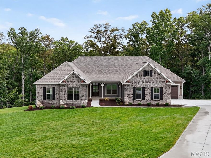 MOVE IN READY!  Spectacular NEW CONSTRUCTION home by Fischer and Frichtel on a 3.07 Acre wooded cul-de-sac homesite in the stunning Del Creek Crossing neighborhood!  This exquisite ranch offers 4 bedrooms, an Office, 3.5 bathrooms and 3,920 sq ft of finished living space.  This open, spacious and on-trend home will wow you!  The curb appeal is exquisite with a brick and stone facade, James Hardie siding, architectural shingles, oversized 3 car garage with auto-court, sod, professional landscape and lawn irrigation. Features include 9 and 12 foot ceilings, luxury vinyl plank flooring, dynamic window wall in the Great Room, gas fireplace, gourmet custom Kitchen, 6 burner gas cooktop, chimney style range hood, double oven, French door refrigerator, Bosch dishwasher, island, seating bar, quartz countertops and backsplash, stainless steel appliances, 42 inch cabinets with hardware and crown, soft close feature, wrought iron spindles at the stairs, Hearth Room, spa-like primary suite, frameless shower door, bench seat in the shower, comfort height dual vanities with quartz counters,  low E windows, Jack-Jill secondary bath, walk in closets in every bedroom, composite screened deck, walkout basement with tall pour, 37 x 14 patio and more.  The finished lower level adds a Family/Rec Room, bedroom, and full bath.  There is easy access to Highway 70.  Amazing home, park like setting, desirable Wentzville schools, so much to love!