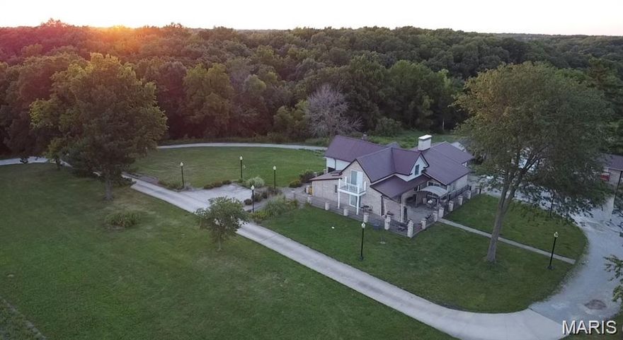 Tucked away at the end of a private drive, this extraordinary 30+/-acre estate blends the warmth of country living with the space and amenities of a true retreat. The main residence spans approx. 4,000 square feet and has been thoughtfully designed for both entertaining and everyday comfort. Four spacious bedrooms, three full baths, and two half baths offer ample room for family and guests. Two expansive living rooms anchor the home—each featuring a dramatic floor-to-ceiling double-sided fireplace that creates a striking focal point. A light-filled sunroom invites you to relax with your morning coffee while taking in serene property views. Downstairs, a finished basement with a wet bar adds the perfect setting for game nights, movie marathons, or hosting celebrations. An attached two-car garage provides convenience and easy access in all seasons. The guest house, at 1,053 square feet, is ideal for extended family, visiting friends, or potential rental income. It includes two comfortable bedrooms, a full bath, a fully equipped kitchen, its own laundry area, and an attached garage—delivering complete independence and privacy for guests. Beyond the residences, the property offers a range of lifestyle amenities. A charming chicken coop and three additional storage sheds support hobbies, livestock, or equipment needs. Endless opportunities for gardening, recreation, or simply enjoying the tranquility of nature. New furnace, Ac, Water Heater --Five minutes to Mark Twain Lake!
